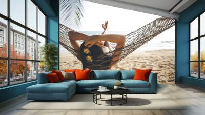 Happy woman relaxing in hammock Wall mural