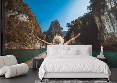 Traveler asian woman relax and travel on Thai longtail boat in Ratchaprapha Dam at Khao Sok National Park Surat Thani Thailand Wall mural