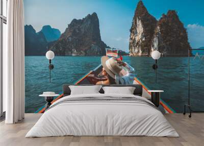 Traveler asian woman relax and travel on Thai longtail boat in Ratchaprapha Dam at Khao Sok National Park Surat Thani Thailand Wall mural