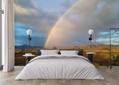 A rainbow arching across the sky after a rain shower is a reminder of the beauty that follows adversity and the promise of new beginnings. Wall mural