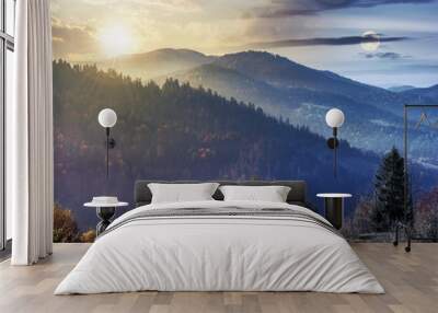 day and night time change concept above countryside in mountains. trees on the edge of a grassy meadow beneath sun and moon. hills rolling in to the distance. hazy weather. Wall mural