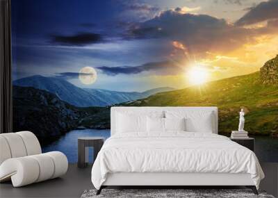 day and night time change concept above summer landscape with lake on high altitude. beautiful scenery of fagaras mountain ridge. open view in to the distant peak beneath a clouds with sun and moon Wall mural