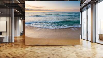 sunrise at the sea. beautiful summer landscape on the sandy beach. green waves rush on the shore in golden light Wall mural