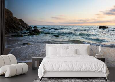 sunrise on the beach. beautiful summer scenery. rocks on the sand. calm waves on the water. clouds on the sky. wide panoramic view Wall mural