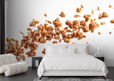 Close-up of granola scattered against a white background. Healthy breakfast food with oats, nuts, and honey forming a textured, crunchy mix. Wall mural