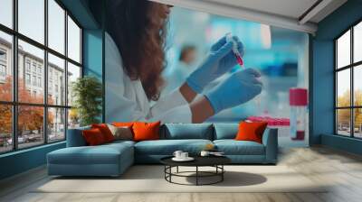 A Scientist in a Lab Coat and Blue Gloves Dropping Blood into a Test Tube Rack Wall mural