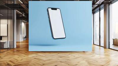 Black Smartphone with White Screen Floating Against a Light Blue Background Wall mural