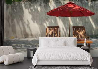 Two Wooden Lounge Chairs with a Red Umbrella on a Sandy Beach Wall mural