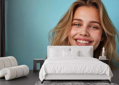 Young beautiful smiling happy woman with blonde wavy hair isolated on pastel flat background with copy space. Wall mural