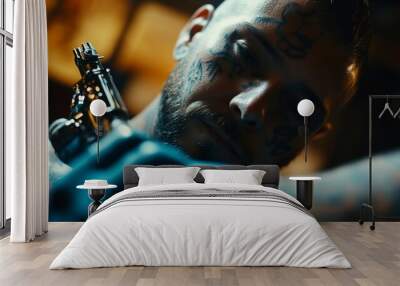 A tattooed man holds a tattoo gun in his hand. Wall mural