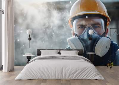 Construction worker wearing a respirator and safety goggles looks intently into the camera while standing in a cloud of dust. Wall mural