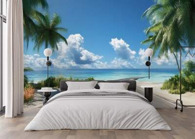 Winding road leading to a tropical beach with palm trees on both sides and a blue sky with white clouds. Wall mural