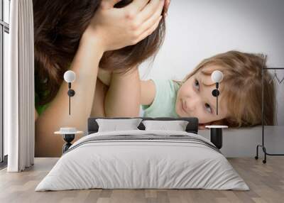 Small family. Single mother has financial problems. Her little daughter calms down sad mother. Wall mural