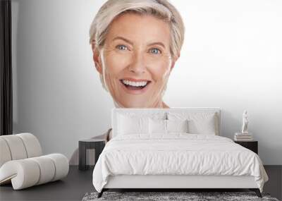 A joyous elderly caucasian woman confidently smiling and looking cheerful while showing her denture in a studio isolated on a png background. Wall mural