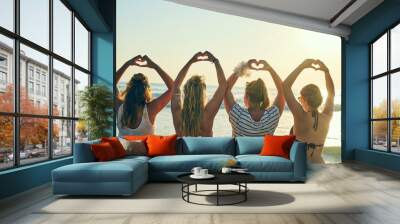 Back, women and friends with hand heart at beach for summer vacation, bonding and travel together. People, love gesture and celebration support for reunion hope, tropical horizon and Miami morning Wall mural