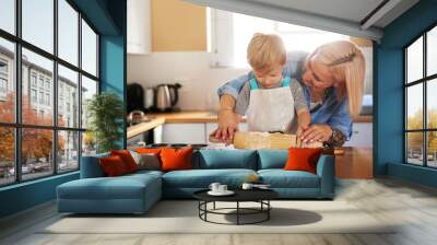 Baking, mother and boy child with dough in kitchen for teaching, learning or development in home. Recipe, happy woman and young kid with rolling pin for sweet snack, pastry dessert or cookies Wall mural