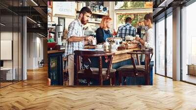 Barista, woman and cafe as waitress in small business with customer in restaurant or coffee shop. Working people, cafeteria and client for food service with entrepreneur in startup in New York City Wall mural