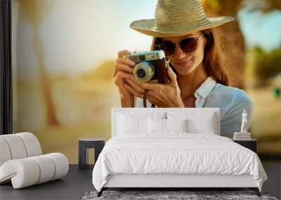 Beach, holiday and woman with camera in photography for outdoor adventure, summer vacation or memory. Photographer, smile and portrait with sunglasses for travel blog, documentary and tourism in Bali Wall mural