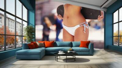 Bikini, body and girl with skateboard in city for outdoor adventure, travel and weekend vacation. Street, hobby and stomach of person in summer for sunshine, fun trip and skater in Los Angeles Wall mural