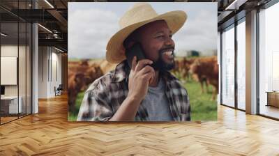 Black man, farmer and phone call with cows for conversation, agriculture or communication in countryside. Happy African or male person talking on mobile smartphone with livestock or cattle on farm Wall mural