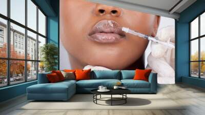 Black woman, collagen and injection for lip filler, cosmetics and beauty on face with hyaluronic acid. Female person, mouth and syringe in studio on white background for treatment or transformation Wall mural