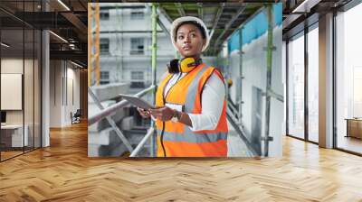 Black woman, tablet and construction for engineering, thinking and site assessment with floor plan. Architect, tech and contractor vision for project management, building development and renovation Wall mural