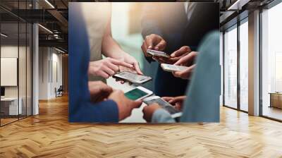 Business people, group and hands with cellphone or networking connection, signal or teamwork. Colleagues, smartphone and huddle together for b2b collaboration or research, syncing or project planning Wall mural