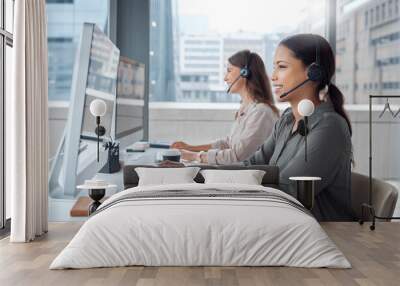 Business people, telemarketing and teamwork with headset for contact at call centre for customer service, help and advice. Female group or virtual assistants in office with computer for communication Wall mural