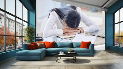 Business woman, tired and sleeping at office desk with burnout risk, overworked and nap for low energy. workplace, exhausted or fatigue of asleep female accountant, finance papers and laptop on table Wall mural