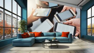 Cellphone, screen and hands of people in group for networking on social media, mobile app or internet. Technology, mockup and above in circle with phone for connectivity, contact or notification. Wall mural