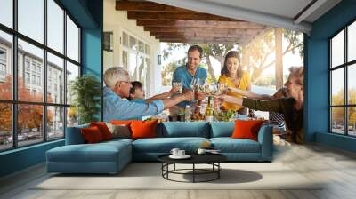 Cheers, wine and family in backyard for food, celebration and eating in happy bonding together at table. Children, parents and grandparents toast with drinks, smile and lunch on patio for holiday fun Wall mural