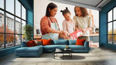 Children, woman and help with baking in kitchen for support, development and learning cooking recipe. Family, mother and kids pouring flour in bowl on table for ingredients, preparation and teaching Wall mural