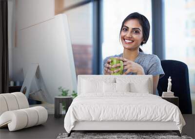 Coffee cup, computer and portrait of creative Indian woman in office with confidence, relax or smile at startup. Design, pride and happy face of online developer with professional consultant on break Wall mural