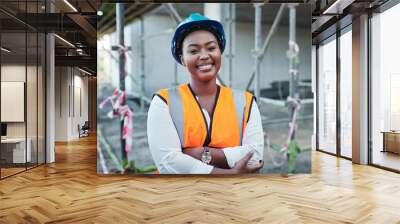 Construction site, architecture and black woman in portrait with arms crossed, maintenance or inspection. Engineering, business person or happy manager with helmet for safety, development or building Wall mural