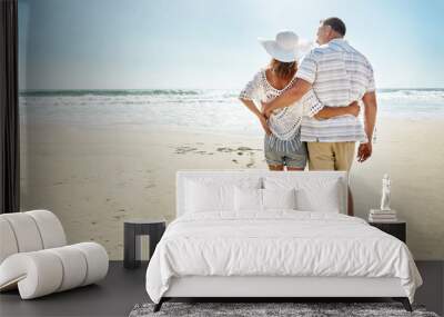 Couple, back and walk on beach together on getaway, summer vacation and relationship bonding for commitment. Married, people and tropical ocean holiday with love, rHUG and wellness with tourist Wall mural