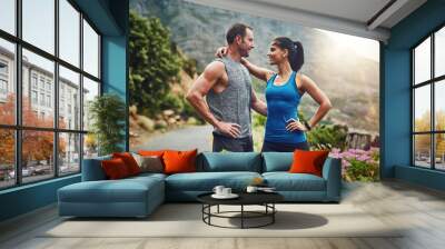 Couple, hug and fitness in nature with love, hold and exercise on mountain trail. Happy man, woman and together at sunrise for wellness, training and support in sportswear for motivation or marathon Wall mural