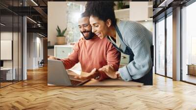 Couple, man and woman with laptop on table for online research and reading blog, with support in home. Love, male and female person together with technology on desk for internet connection or bonding Wall mural