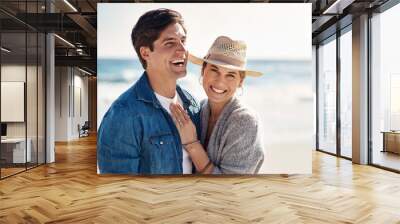 Couple hug, portrait and smile at beach for sunshine, holiday romance, love together and honeymoon. Happy woman, man and face by ocean for summer vacation, peace and marriage with trust in Argentina Wall mural