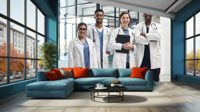 Diversity, portrait and doctors in clinic for teamwork, wellness and health services. Support, happiness and medical professional with stethoscope for solidarity, community or internship in hospital Wall mural