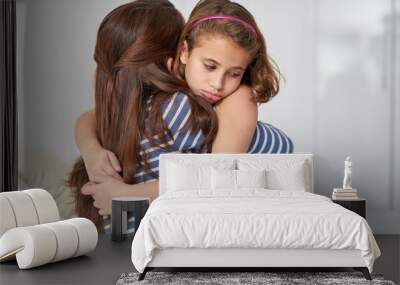 Face, mother and sad girl hug for support in home for care, safety and bonding together with empathy. Depressed, love and single parent mom with kid for security, daughter or child in family house Wall mural