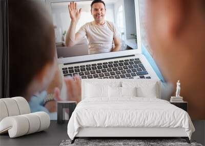 Family, video call and father wave on laptop screen for communication, talking or bonding. Happy man, hello and virtual chat with parent of kid on computer for conversation, care or greeting in home Wall mural