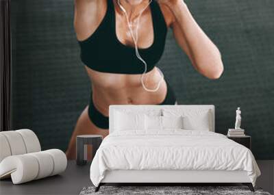 Fitness, music and portrait with body of woman in gym for health challenge, training or wellness. Earphones, exercise and athlete person in sports club for performance or physical workout from above Wall mural