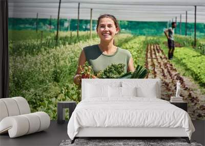 fresh produce coming right up. portrait of an attractive young woman carrying a crate full of vegeta Wall mural