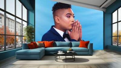 Gay man, fashion and thinking in studio with daydream, vision and memory in formal style by blue background. Queer person, lgbtq model and ideas in suit, trendy and elegant clothes with makeup Wall mural