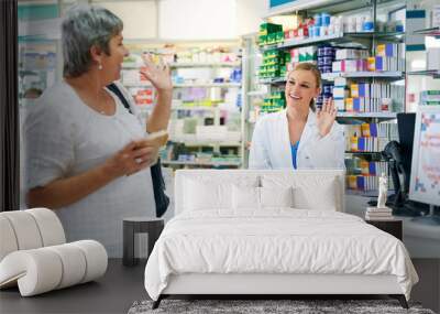 Happy, customer and shopping at pharmacy for medicine, pills or drugs for healthcare and service. Pharmacist, wave and thank you woman at store with sale of supplements or trust help at drugstore Wall mural