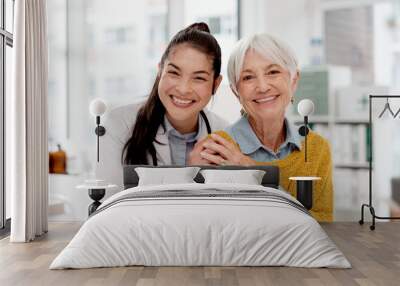 Happy, hug and face of a doctor with a woman for medical trust, healthcare and help. Laughing, care and portrait of a young nurse with a senior patient and love during a consultation at a clinic Wall mural