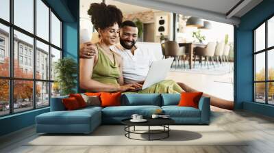 Happy, relax and couple in home on laptop for bonding, loving relationship and together in kitchen. Marriage, embrace and man and woman on computer for internet banking, website and online shopping Wall mural