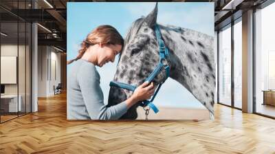 Happy, woman and calm horse on farm for equestrian, training or adventure in countryside. Girl, care and stroke animal on ranch with peace and rider with healthy pet or vet helping at sanctuary Wall mural