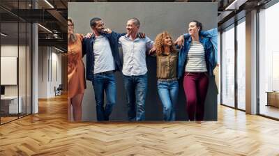 Happy business people, diversity and team with inclusion for company growth together on a wall background. Group of diverse, young employees and smile in row or line for creative startup or about us Wall mural