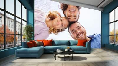 Happy family, below and portrait in outdoor for holiday with support, collaboration for travel break or journey. Man, woman and girl for solidarity on vacation in England, smile in circle with sky Wall mural